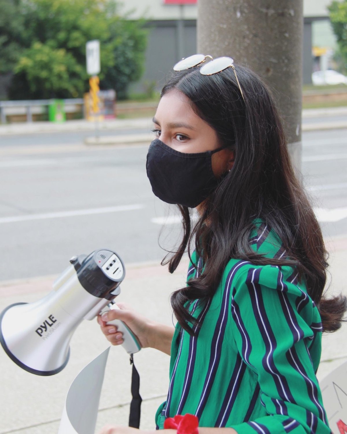 Arissa with a megaphone at a rally for girls' education