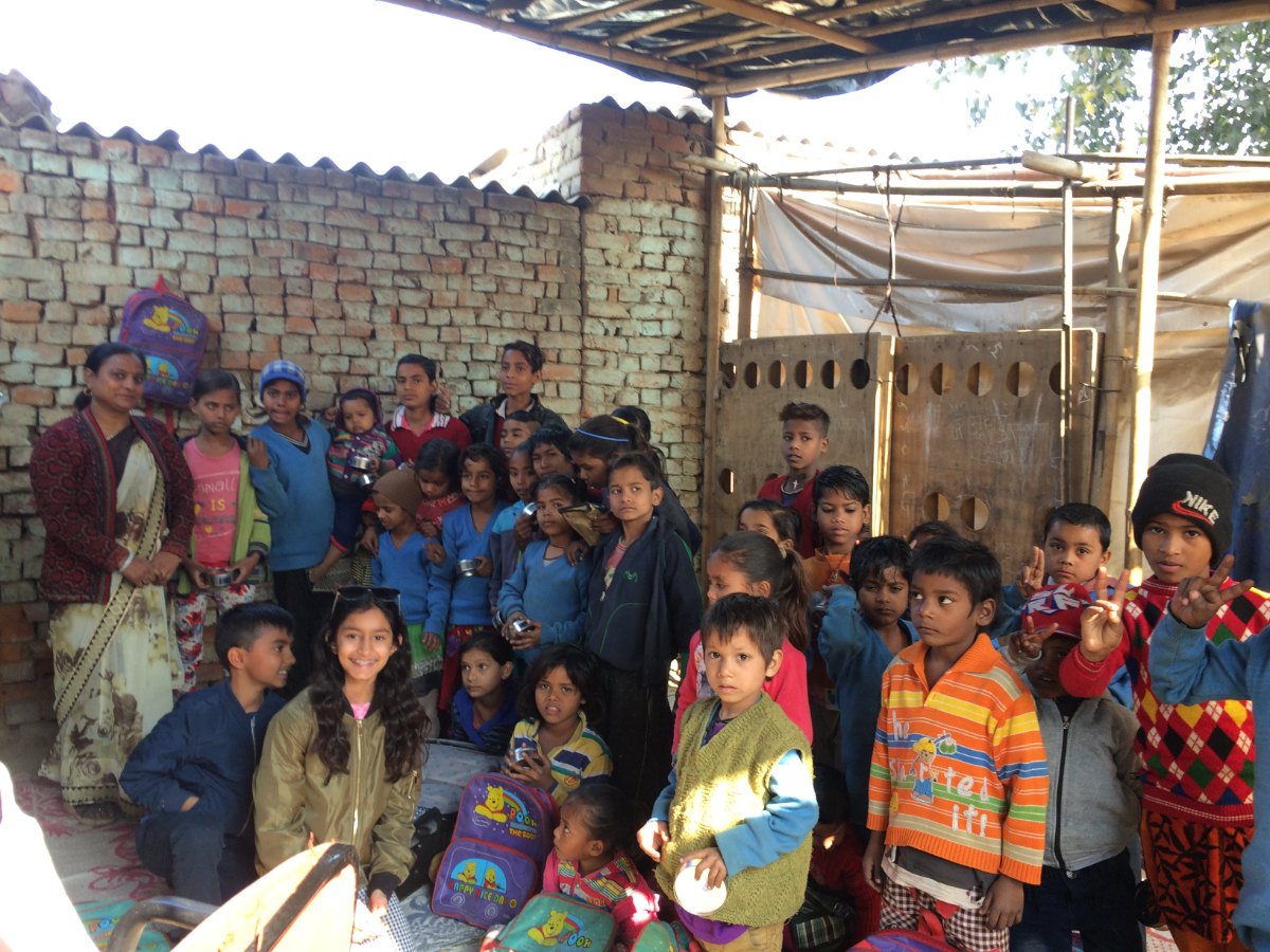 Children with backpacks at a community classroom in India